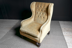 mustard yellow coloured Victorian winged arm chair buttoned back Turned mahogany front legs sabred back legs ceramic brass castors Stamped Cornelius V. Smith English circa 1880