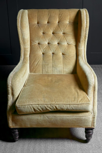 mustard yellow coloured Victorian winged arm chair buttoned back Turned mahogany front legs sabred back legs ceramic brass castors Stamped Cornelius V. Smith English circa 1880