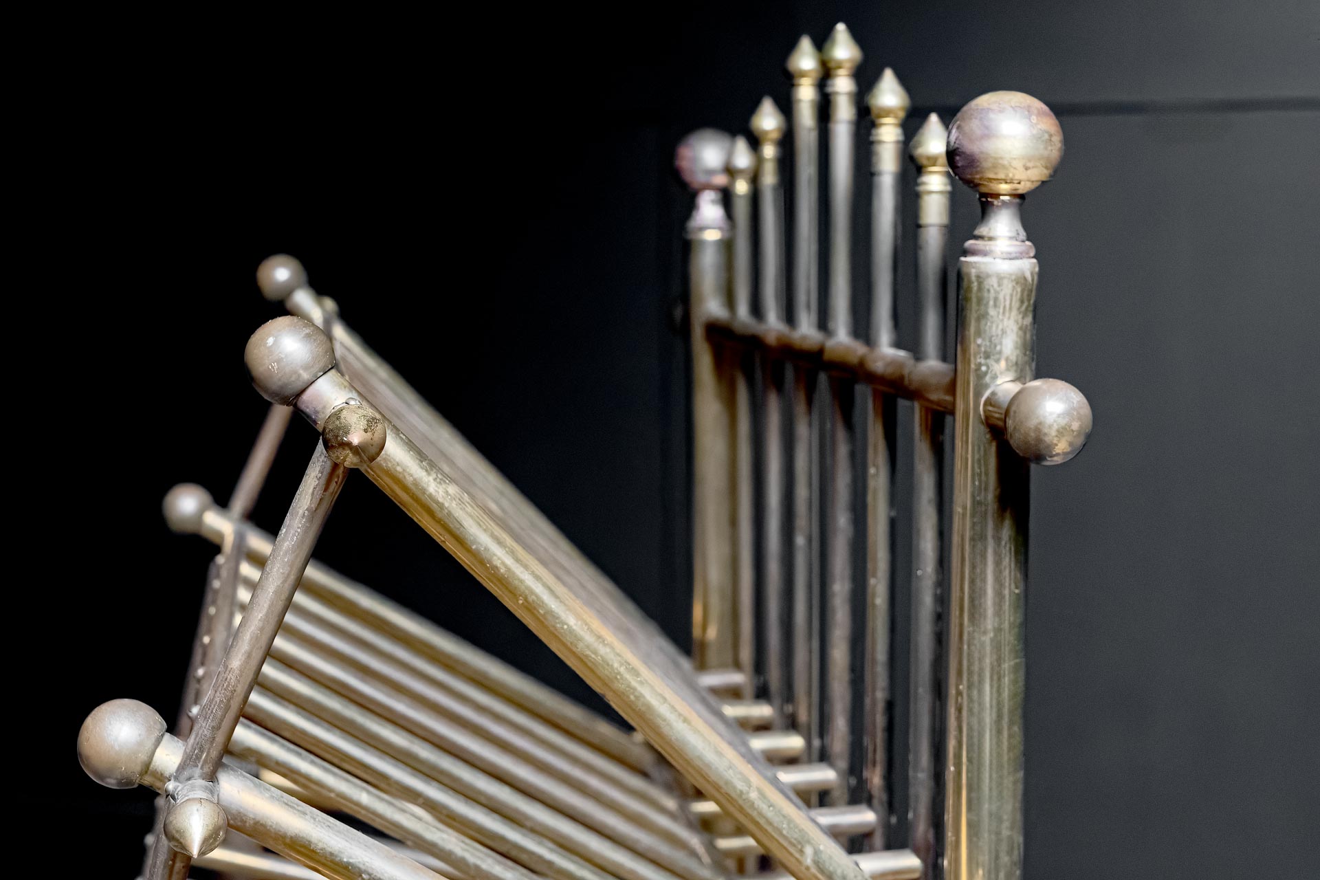 Gothic styled German brass shoe rack  finials globed ends  oxidised patina ageing  circa 1920