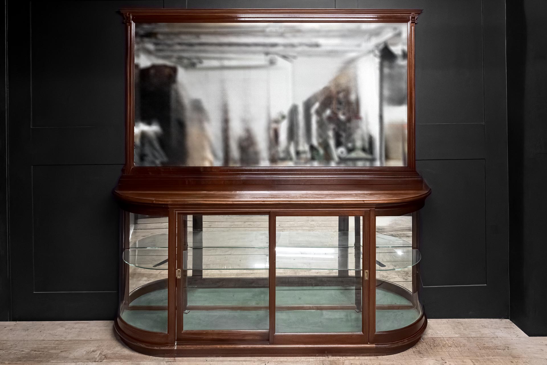 Victorian 1890 antique quarter bow cornered glazed display cabinet mahogany bevel edged mirror shop shop bar counter  restaurant retail coffee showcase sliding doors patinated brass cup pull handles iron hardware